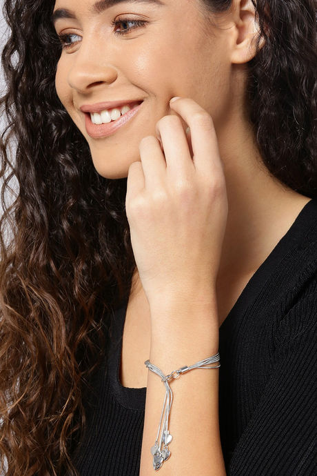 Sterling silver charm bracelet against a black background Stock Photo -  Alamy
